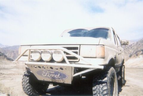 1988 Ford Bronco - This 1988 Ford Bronco features a custom front bumper with integrated lights and a Ford logo.