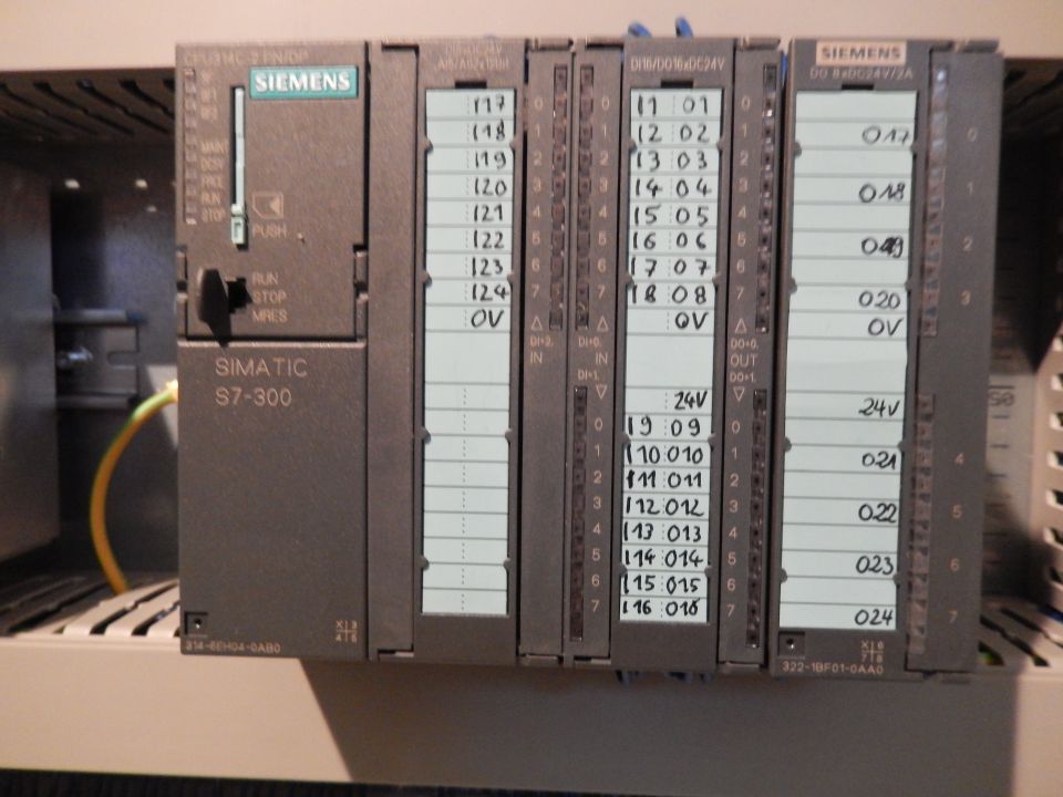 Siemens S7-300 PLC with handwritten labels on modules.