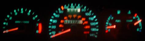 1993 Ford Taurus - The glowing green dashboard gauges show the tachometer, speedometer, fuel, and temperature readings.
