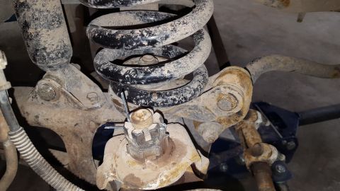 1995 Ford Bronco - Vehicle suspension components, including a coil spring and shock absorber, are visible in this close-up.