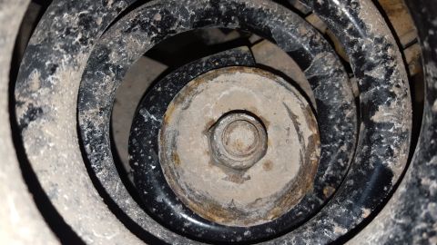 1995 Ford Bronco - This image shows a close-up view of a vehicle's suspension spring and a bolt, not the entire vehicle.