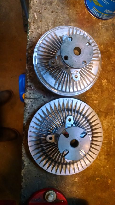 1994 Ford Bronco - Two fan clutches are shown on a wooden surface, one above the other.