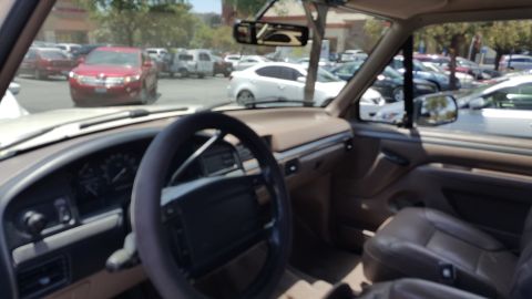 1995 Ford Bronco - Interior view of a 1995 Ford Bronco, parked in a lot with other vehicles.
