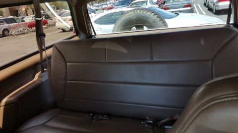 1995 Ford Bronco - Interior view of a vehicle, showing seats and a spare tire mounted externally.