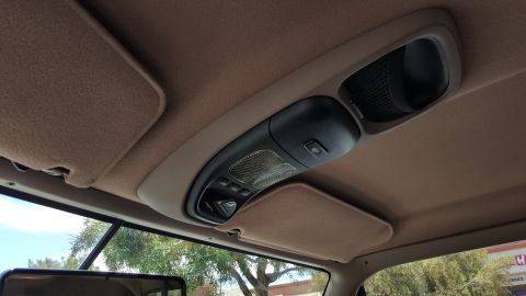 1995 Ford Bronco - View of the overhead console and sun visors inside a vehicle.