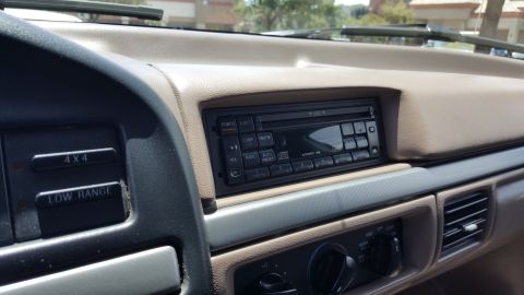 1995 Ford Bronco - Interior view of a 1995 Ford Bronco, the dashboard, radio, and 4x4 controls.