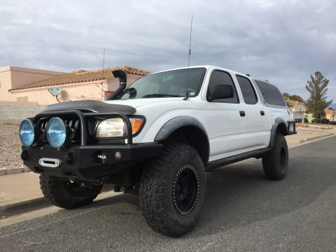 2001 Toyota Tacoma - Modified 2001 Toyota Tacoma pickup truck with off-road accessories parked on a street.