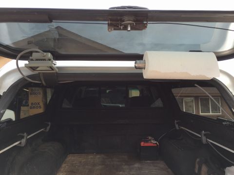 2001 Toyota Tacoma - Interior view of a truck bed, showing a paper towel dispenser and a battery, with 'BOX BROS' boxes in the background.