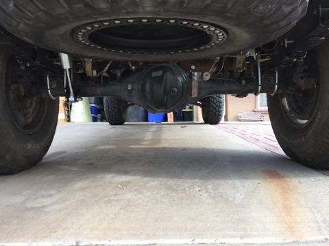 2001 Toyota Tacoma - Rear axle assembly and spare tire visible from underneath a truck.