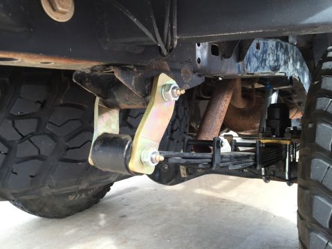 2001 Toyota Tacoma - Close-up view of the rear suspension system of a truck, showing leaf springs and a shock absorber.