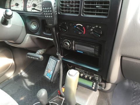 2001 Toyota Tacoma - The interior of a 2001 Toyota Tacoma features a CB radio and microphone mounted on the dashboard.