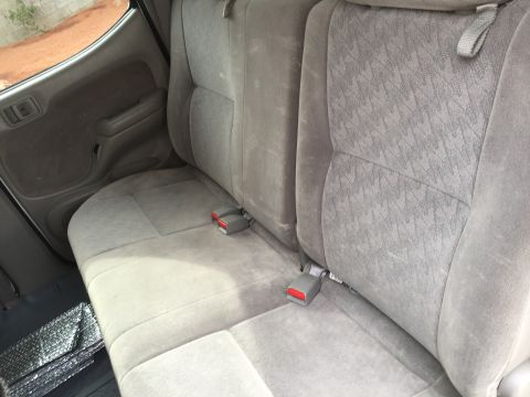 2001 Toyota Tacoma - Interior view of the rear seats and door panel of a vehicle.