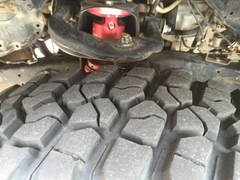 2001 Toyota Tacoma - Truck's front suspension and off-road tire detail.