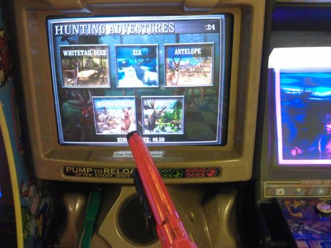 2006 Honda RANCHER - Arcade game screen for 'HUNTING ADVENTURES' with a toy gun in front.
