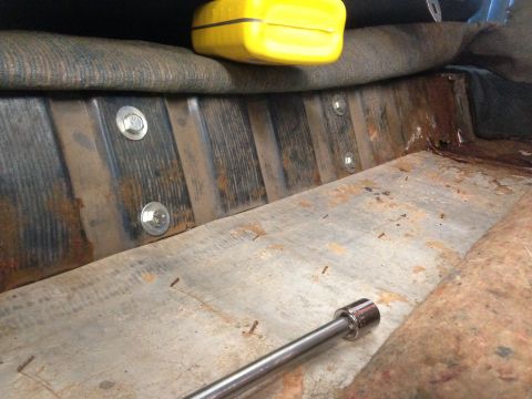 1979 Ford Bronco - Close-up of the interior floor area, showing bolts and a socket wrench, with a Supermotors.net watermark.