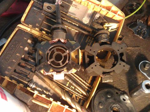 1994 Ford Bronco - Starter motor parts and tools are laid out on a workbench.