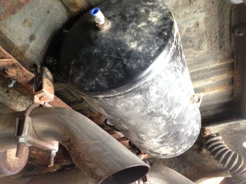 1979 Ford Bronco - Underside view of an air tank and exhaust system, likely an aftermarket addition.