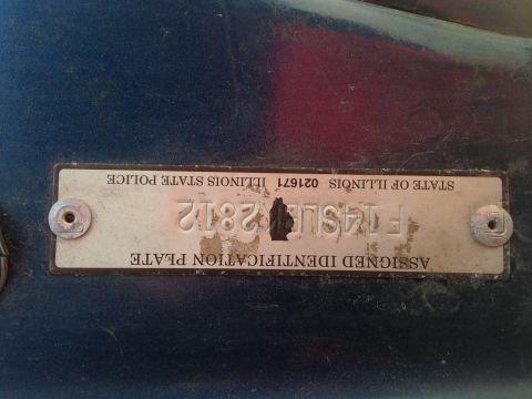 1979 Ford Bronco - Close-up of an Illinois State Police assigned identification plate with VIN F14SL2812.