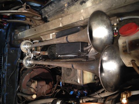 1979 Ford Bronco - Triple air horns are visible mounted beneath the vehicle's chassis, with associated plumbing and electrical components.