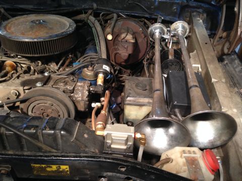 1979 Ford Bronco - Engine bay with air horns and compressor. Year is not identifiable.