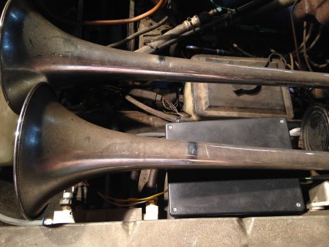 1979 Ford Bronco - Air horns are visible in a cluttered engine bay, with visible hoses and wiring.