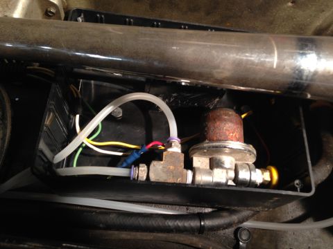 1979 Ford Bronco - Close-up of an air suspension valve and associated tubing, mounted within a black housing.