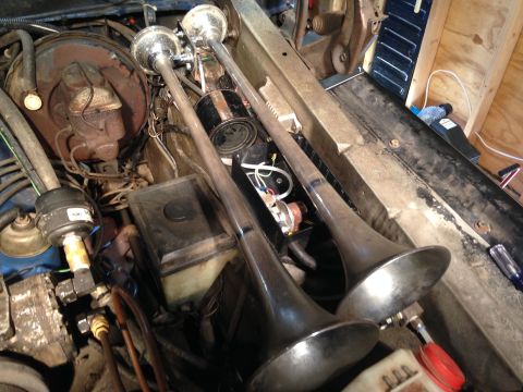 1979 Ford Bronco - Engine bay view showing two chrome air horns mounted.