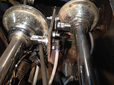 1979 Ford Bronco - Two chrome air horns are visible, attached to a bracket with various hoses and electrical connections.
