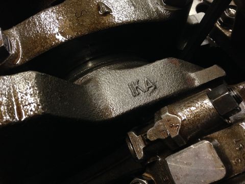 1979 Ford Bronco - This image shows a close-up view of internal engine components, specifically the crankshaft and a connecting rod, with visible stamped mark…