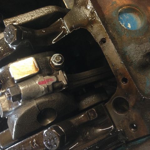 1979 Ford Bronco - Engine block components, including crankshaft and connecting rod, covered in oil.