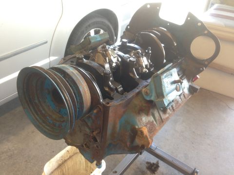 1979 Ford Bronco - Disassembled engine block with crankshaft and pulleys, showing signs of rust and wear.