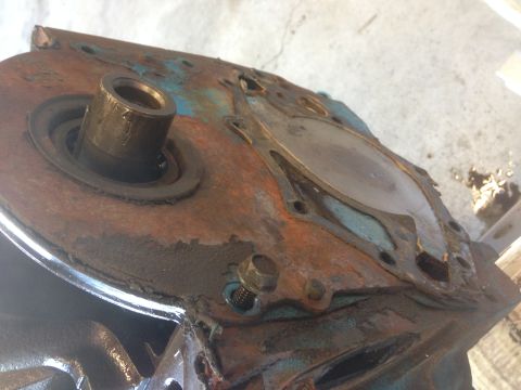 1979 Ford Bronco - Close-up of a heavily rusted engine block component, likely from an older vehicle.