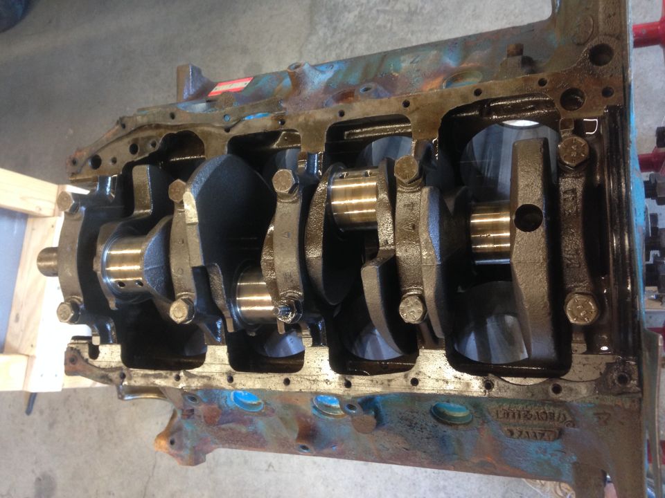 Engine block with crankshaft and connecting rods visible. Some blue and rust coloring on the block