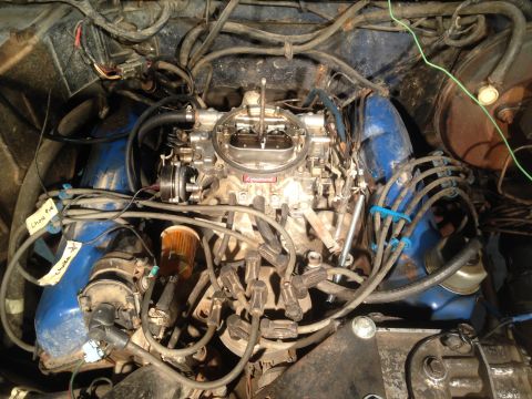 1979 Ford Bronco - Close-up view of an engine bay, showing the carburetor and associated wiring.
