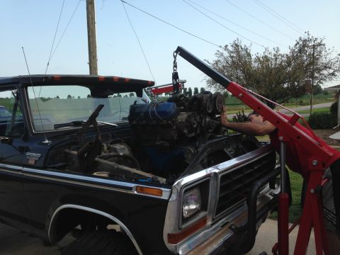 1979 Ford Bronco - Engine removal in progress on a 1979 Ford Bronco using an engine hoist.