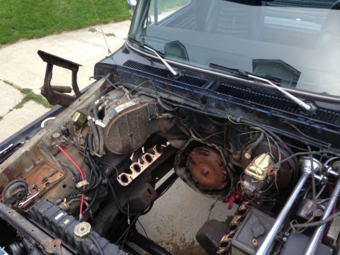 1979 Ford Bronco - The engine bay of a 1978 Ford Bronco shows a disassembled engine and transmission, indicating an ongoing rebuild.