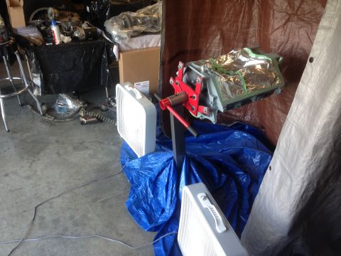 1979 Ford Bronco - Engine on a stand, ready for rebuild or transport, surrounded by shop supplies.