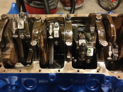 1979 Ford Bronco - Close-up view of an engine's crankshaft and connecting rods, showing internal components during a rebuild.