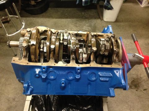 1979 Ford Bronco - A blue engine block with the crankshaft and connecting rods exposed is shown, likely during a rebuild.
