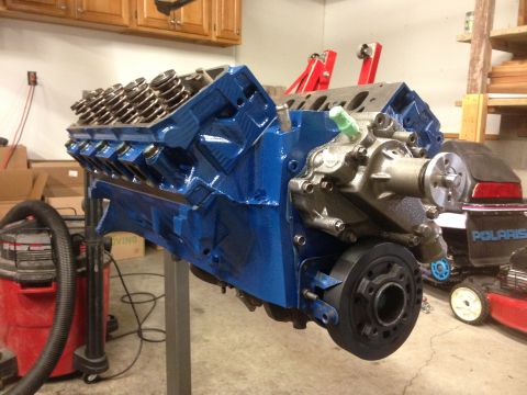 1979 Ford Bronco - A freshly painted engine block sits on a stand in a workshop, ready for reassembly.