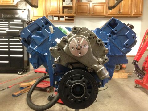 1979 Ford Bronco - A blue V8 engine assembly, likely undergoing rebuild, is shown with its water pump and crankshaft pulley.