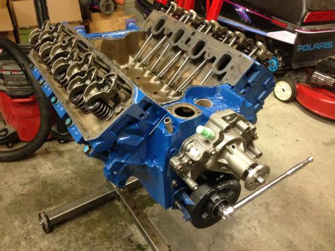 1979 Ford Bronco - V8 engine block on an engine stand, with valve covers removed and water pump attached.