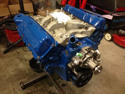 1979 Ford Bronco - A blue painted V8 engine is mounted on an engine stand, ready for installation or rebuild.