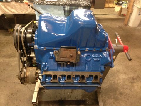 1979 Ford Bronco - A blue engine sits on a stand, ready for installation.