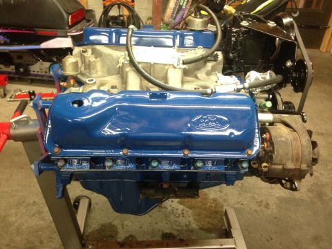 1979 Ford Bronco - A blue Ford V8 engine is mounted on an engine stand, ready for installation or work.