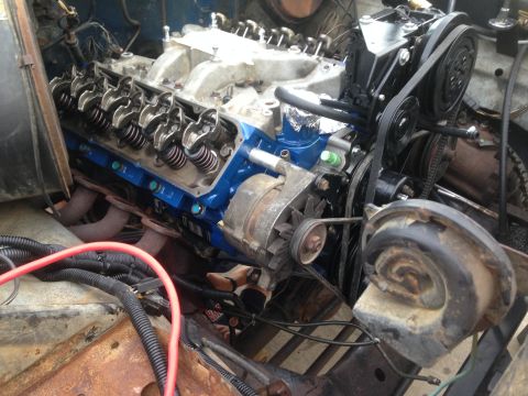 1979 Ford Bronco - Close-up view of a V8 engine, likely during a rebuild or repair, showing internal components and accessory drives.