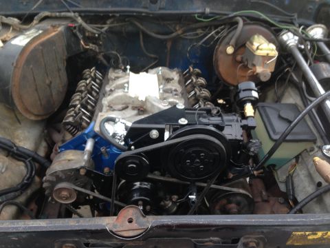 1979 Ford Bronco - Engine bay view shows a V8 engine with blue painted block and black accessories.