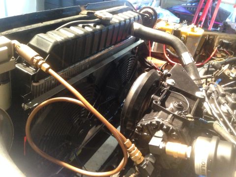 1979 Ford Bronco - Close-up view of an engine bay, showing the radiator, cooling fans, and engine components.