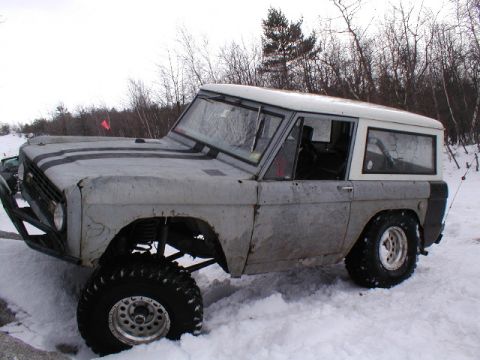 1979 Ford Bronco II - This modified Ford Bronco is shown in a snowy environment with its suspension lifted and large off-road tires.