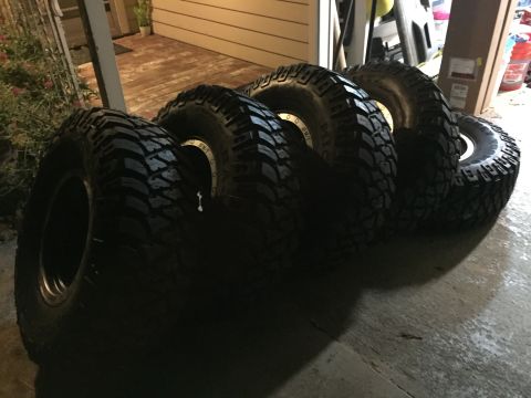 1989 Ford Bronco - Four new off-road tires are ready for installation.